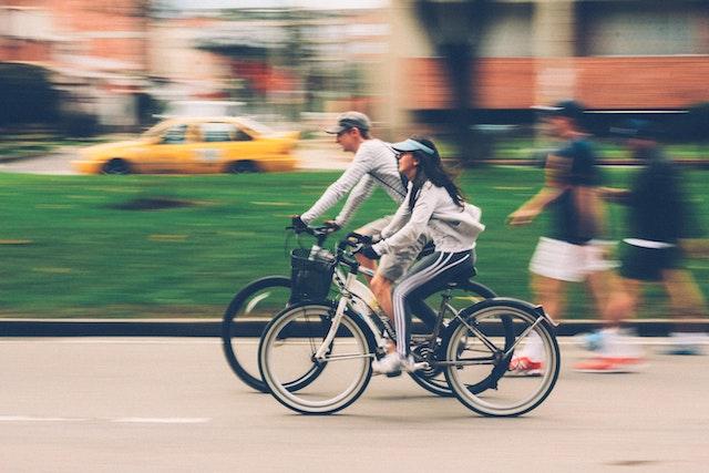Man and woman riding a bicycle.