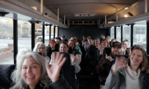 A group of people having fun on a charter bus.