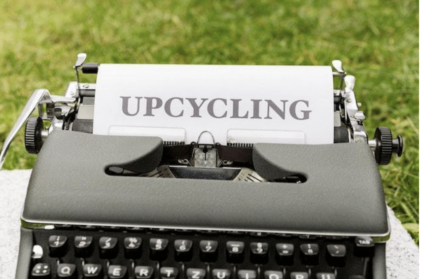 A word “upcycling” typed on the paper standing in the typewriter.