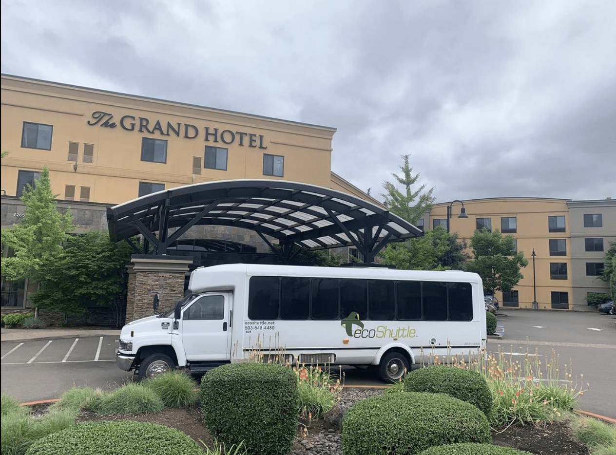 28-Passenger mini-bus picking up at a hotel.