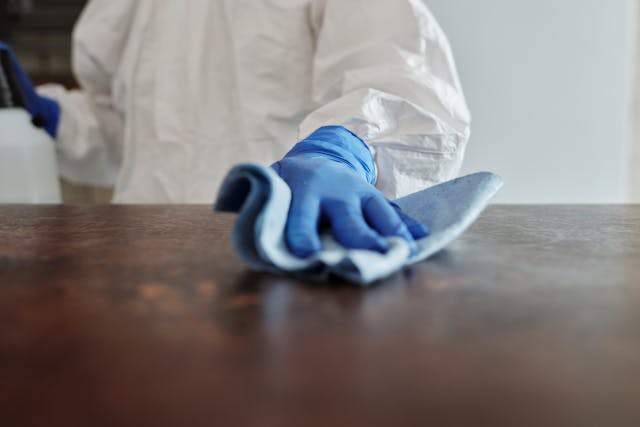 Person cleaning a table.