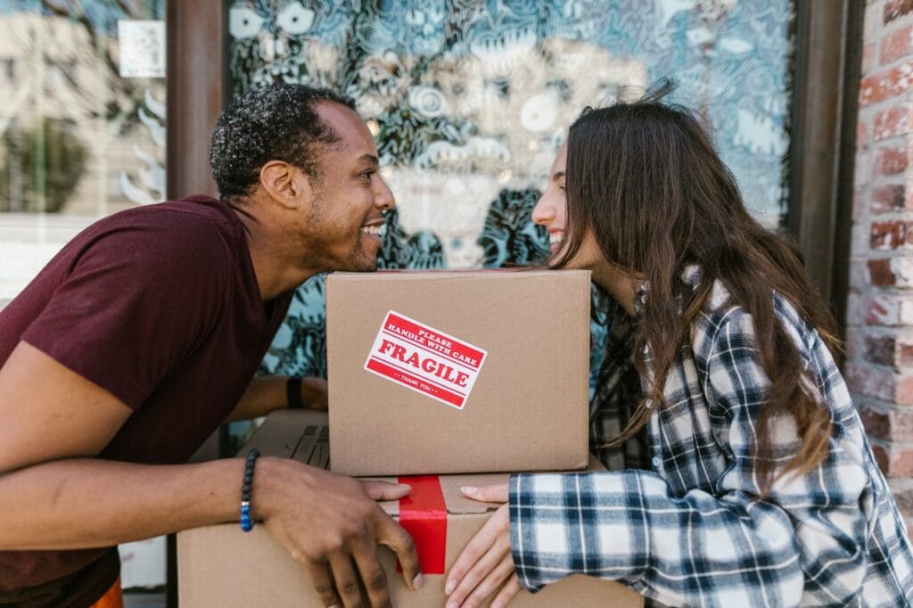  couple holding moving boxes