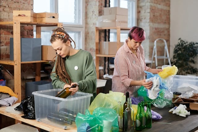People sorting recyclable materials as part of a zero-waste and circular economy effort.