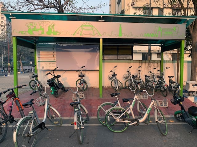  Bicycle sharing station with multiple parked bikes in an urban area